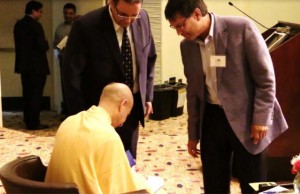 Radhanath Swami signing his book “The Journey Home” for  guests